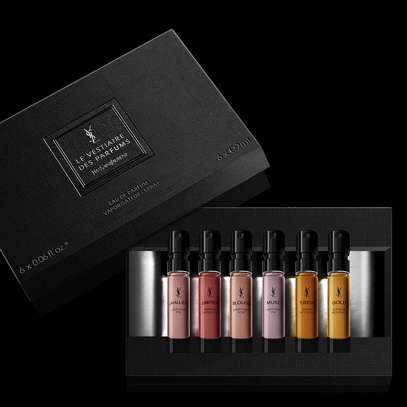 An open black YSL discovery set featuring six miniature perfume sprays in various colors.