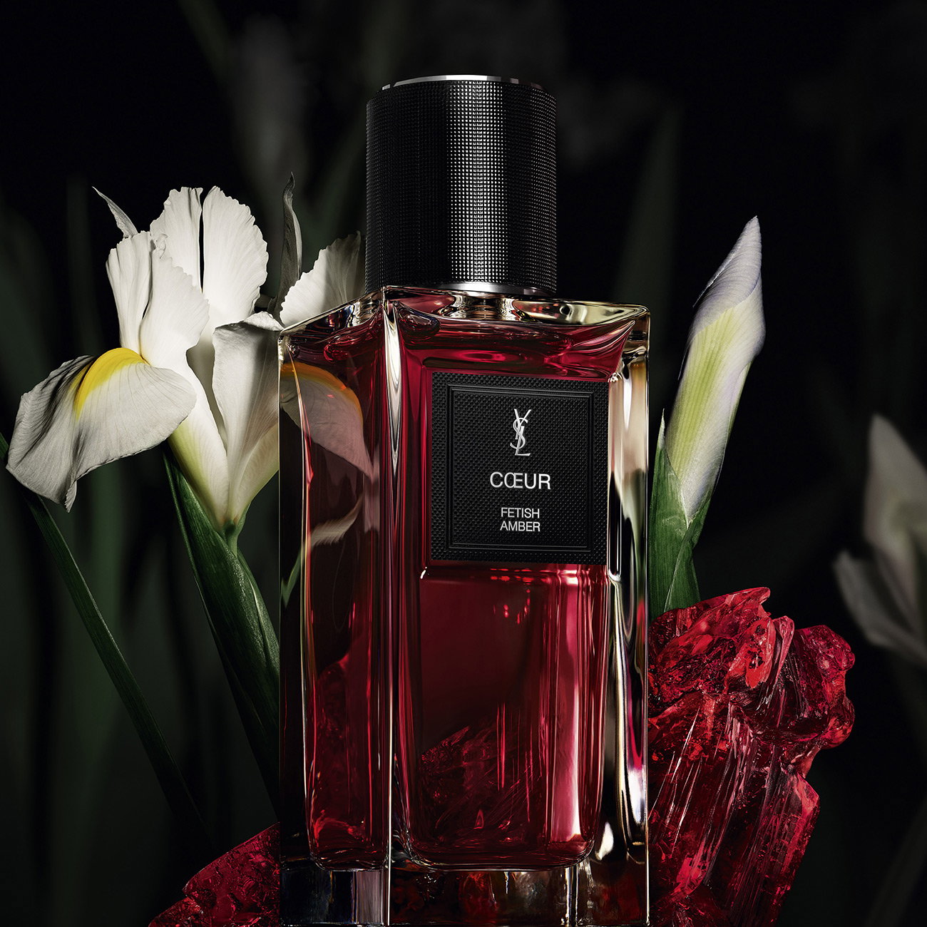 YSL Coeur Fetish Amber perfume bottle with white flowers and red crystals.