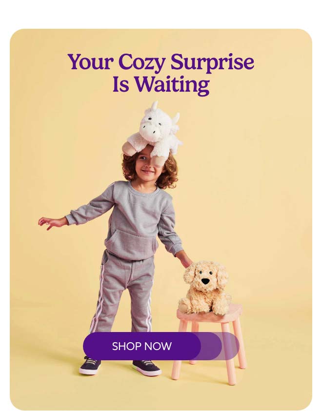 A little boy balancing Warmies on his head. Shop Now.
