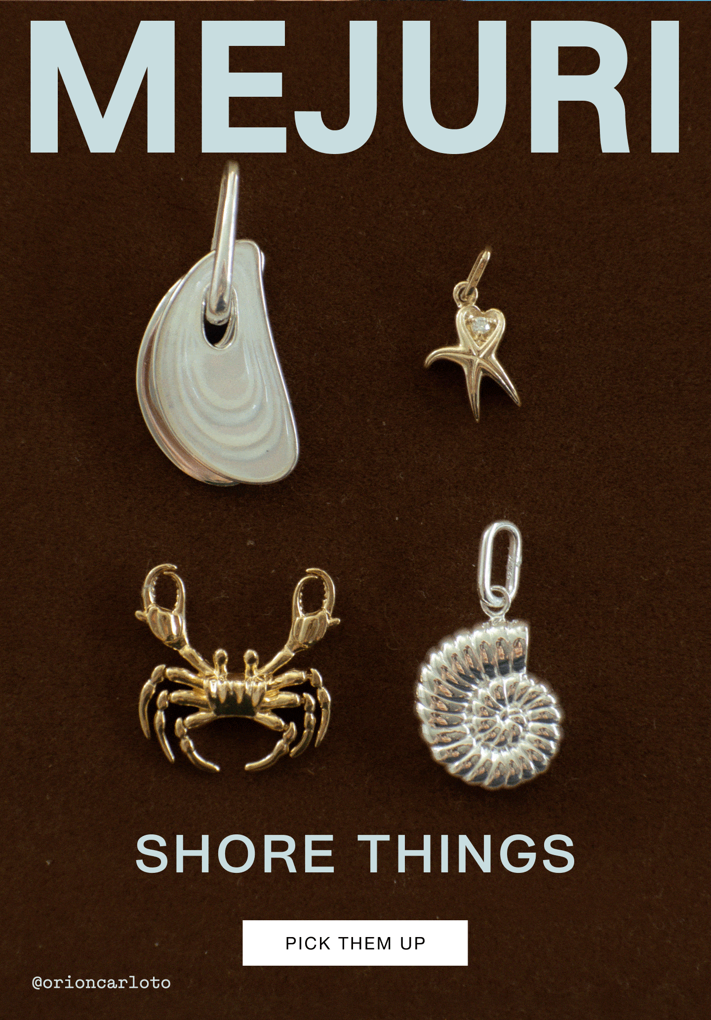 Mejuri Shore Things collection — four ocean-inspired charms displayed on a dark brown background: a silver mussel shell pendant, a gold starfish charm with a diamond heart detail, a gold crab charm, and a silver nautilus shell pendant. Text reads "Shore Things" with a "Pick Them Up" call-to-action button.