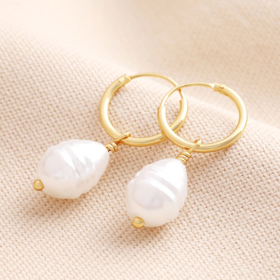 Image of Pearl Drop Huggie Hoops in Gold