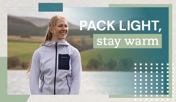PACK LIGHT, STAY WARM. A woman walks alongside a loch wearing Montane Women's Protium CP Hoodie in Purple