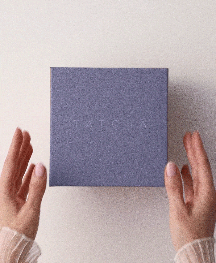 A gif of someone opening a Tatcha box to show a skincare product