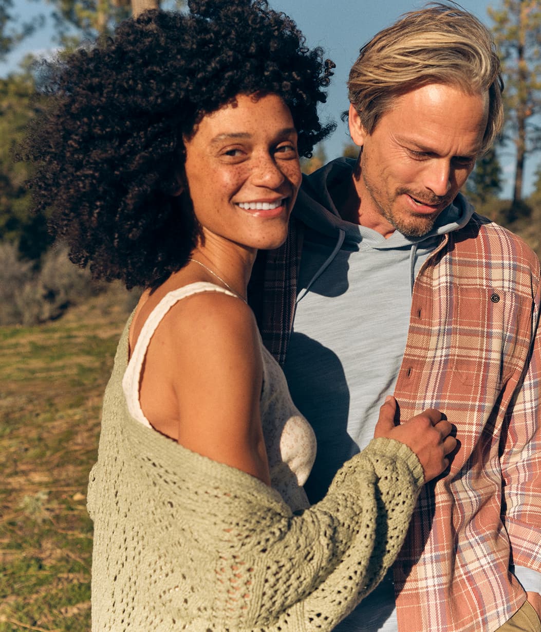 Woman wearing an Eddie Bauer tank top and cardigan. 