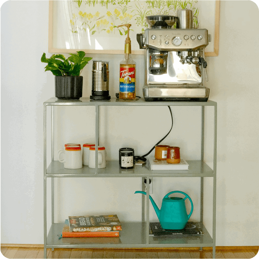 Grey Foshay bookcase used as a coffee station with espresso machine, mugs and supplies.