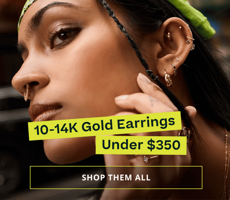Model with geometric gold hoops, studs & nose ring.  Gold earrings under $350. Click here to shop them all