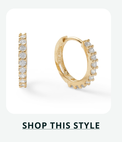 Gold huggies with row of round stones, prong set along the front. Click here to shop this style