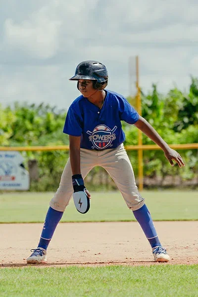 Baseball player leading off base with a sliding mitt