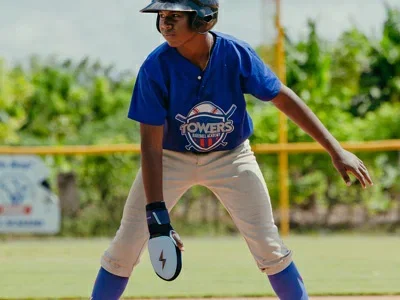 Baseball player leading off base with a sliding mitt