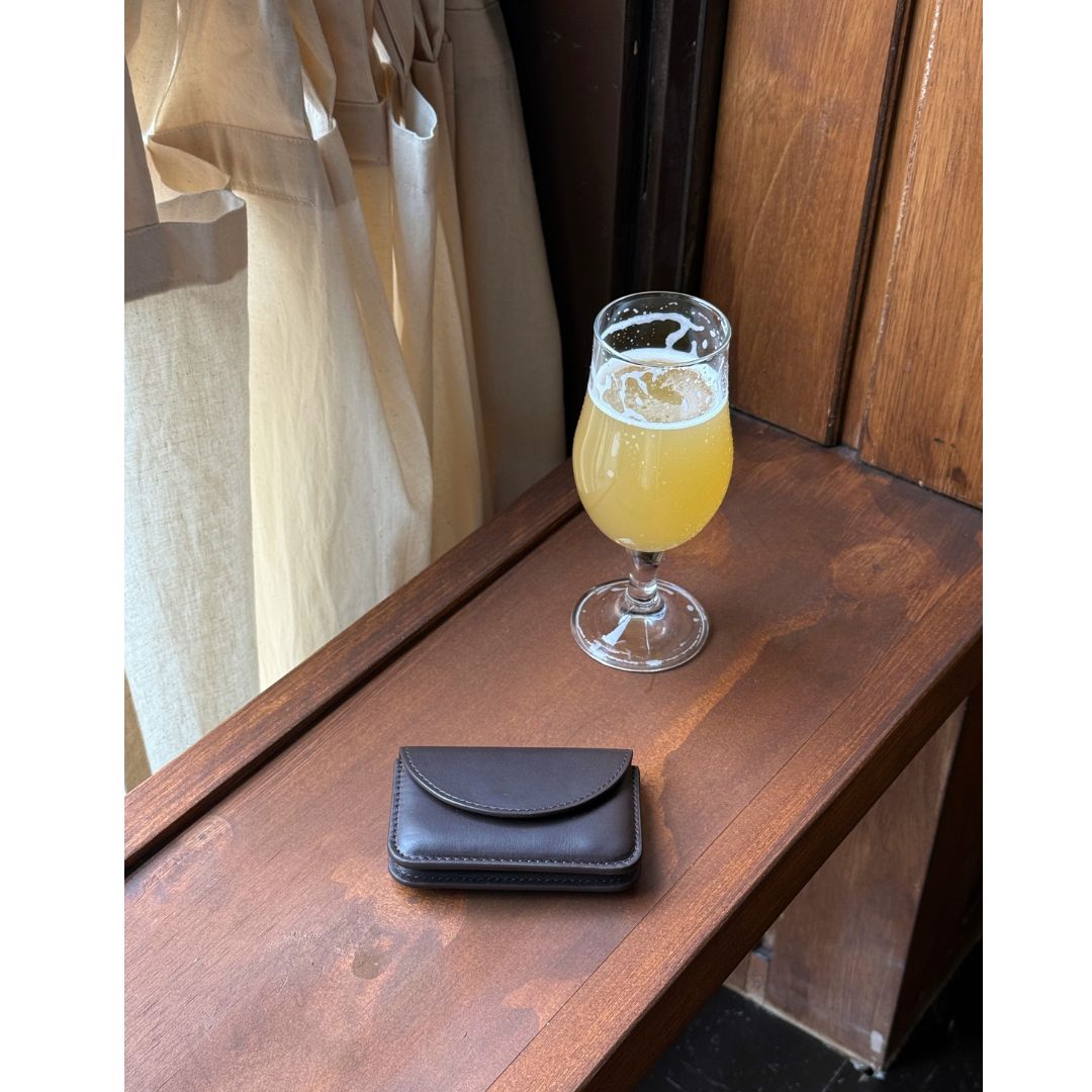 brown leather wallet at a bar
