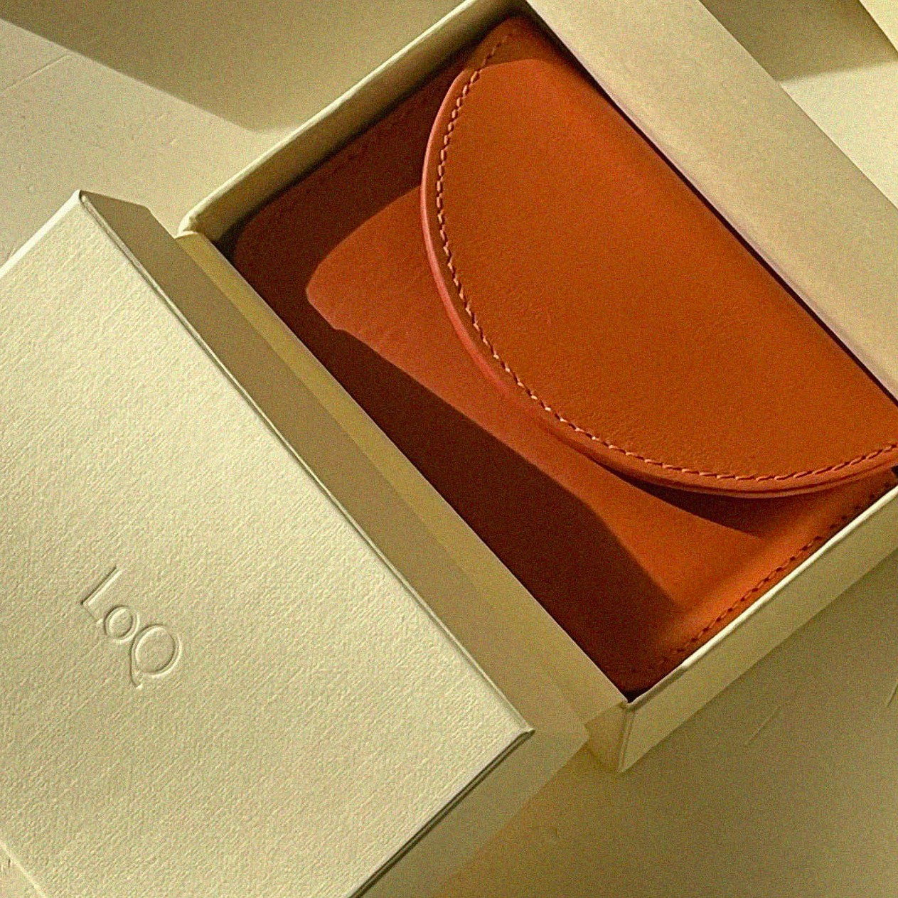 red wallet in its box