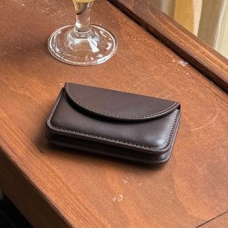 brown wallet on wood table