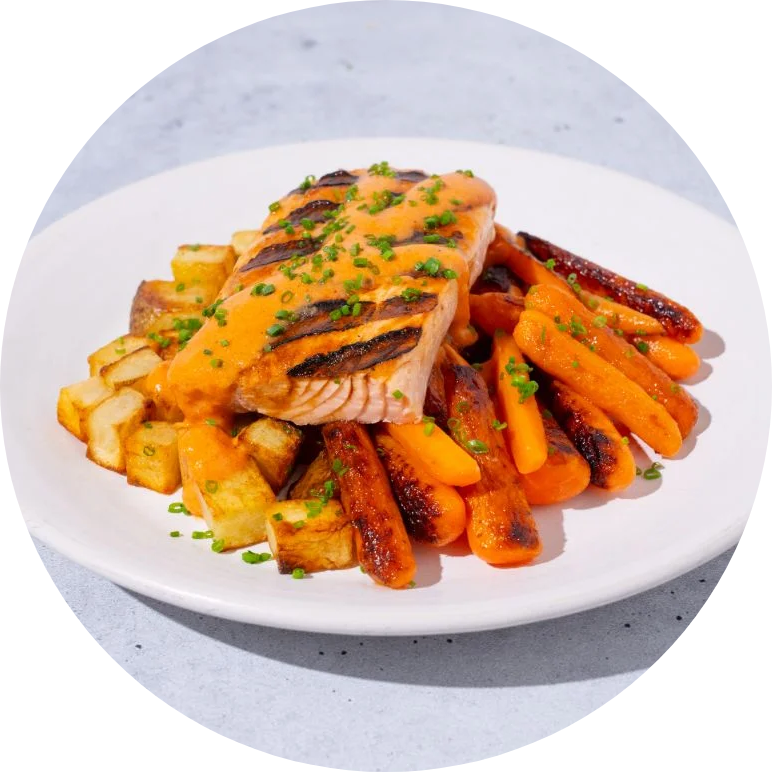 Salmon, roasted carrots, and butternut squash on a white plate