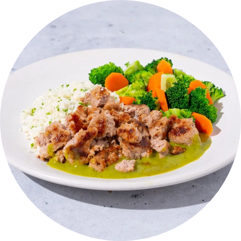 Chicken, cauliflower rice, and mixed veggies on a white plate