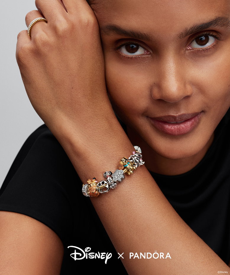 Model wears Disney Pets stacked charm bracelet
