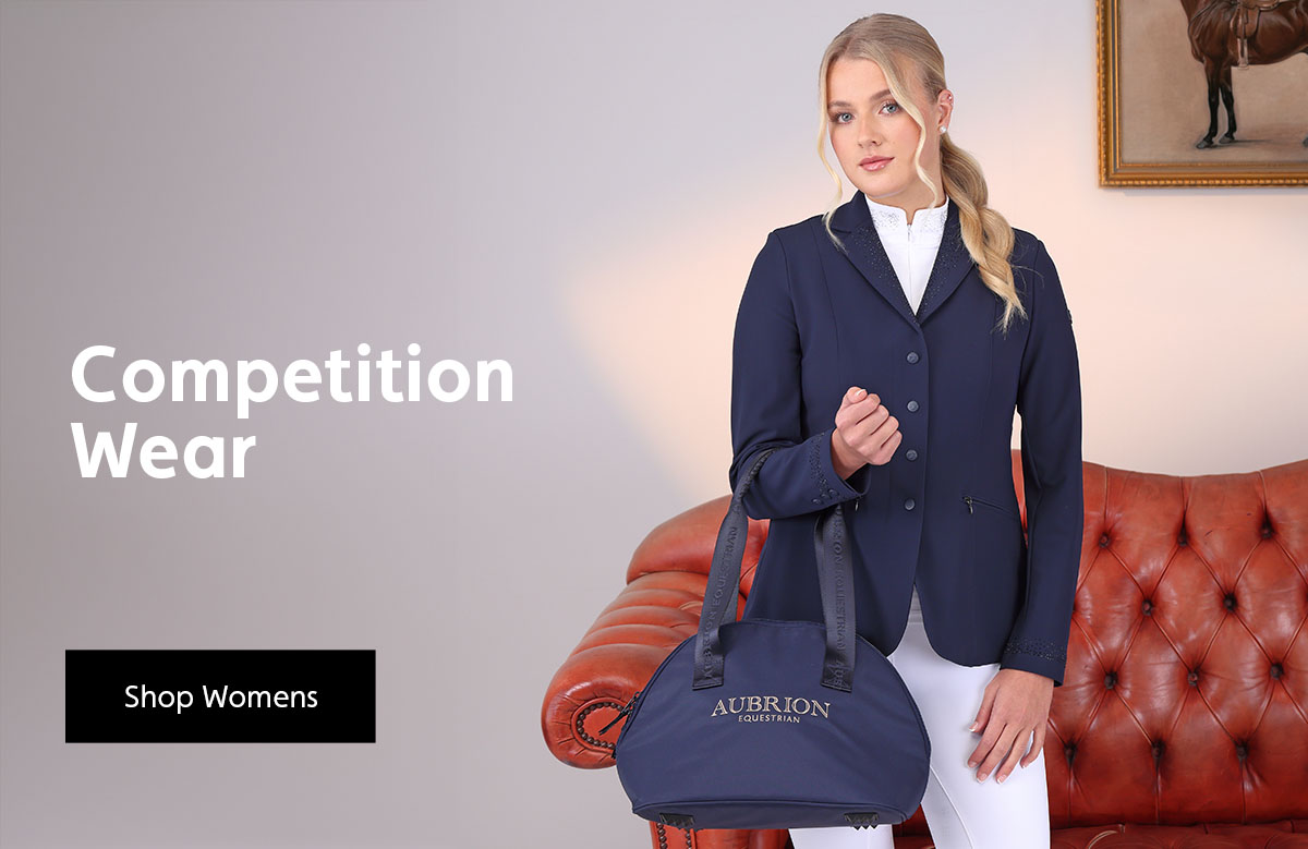 Woman wearing competition wear, holding a Aubrion hat bag