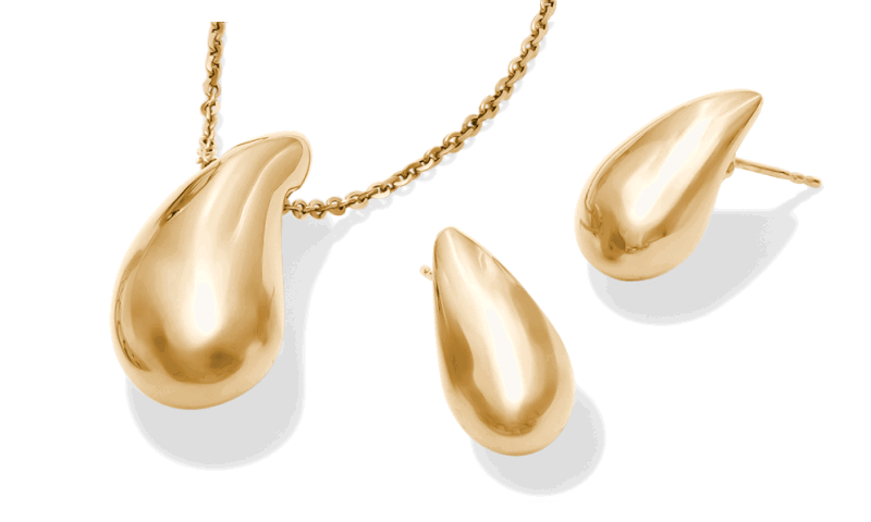 Gold teardrop pendant necklace with matching teardrop stud earrings.