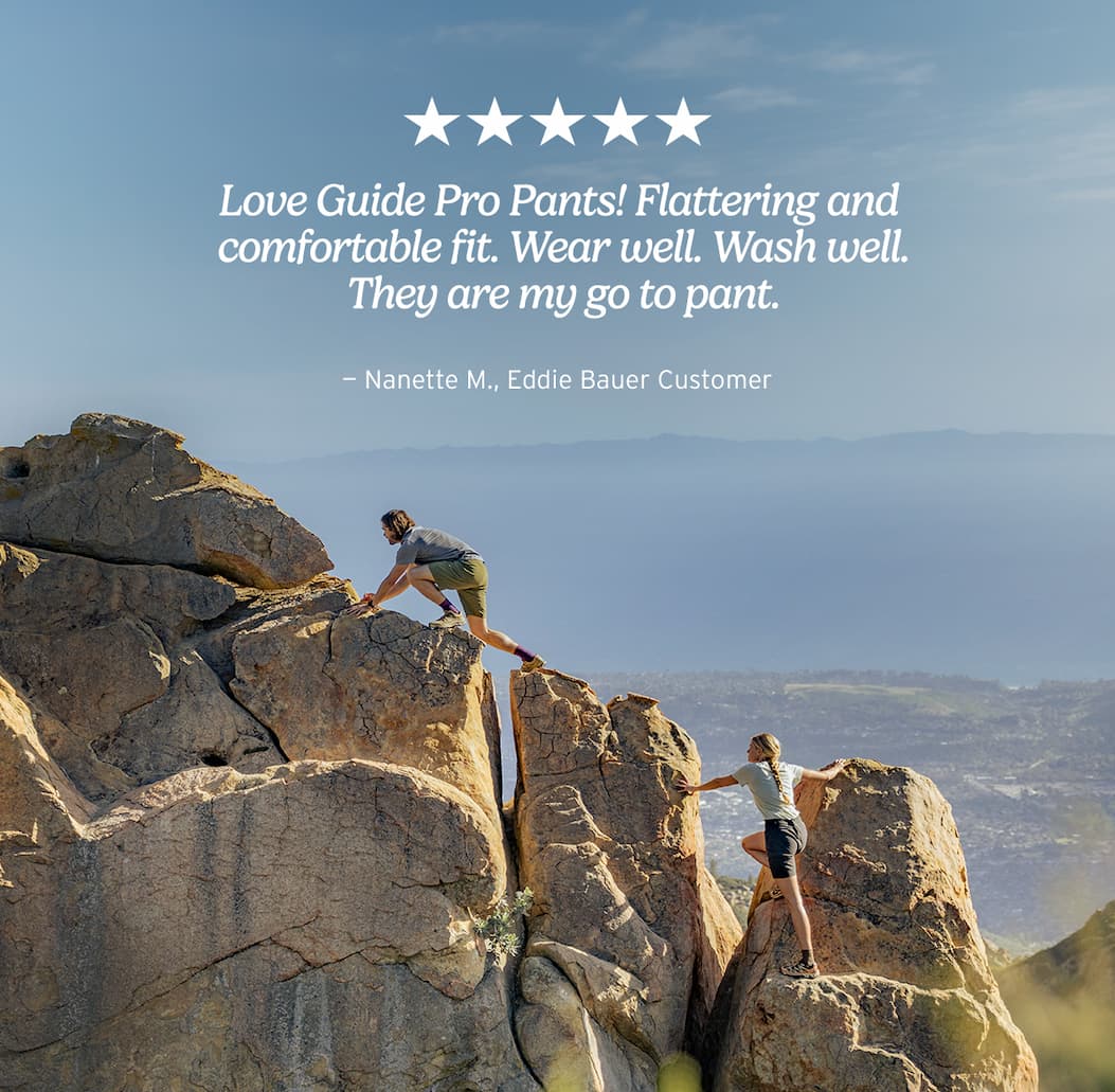 Man and woman rock climbing in Guide Pro shorts.