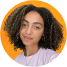 Georgia Chambers has curly hair and wears a pink top.