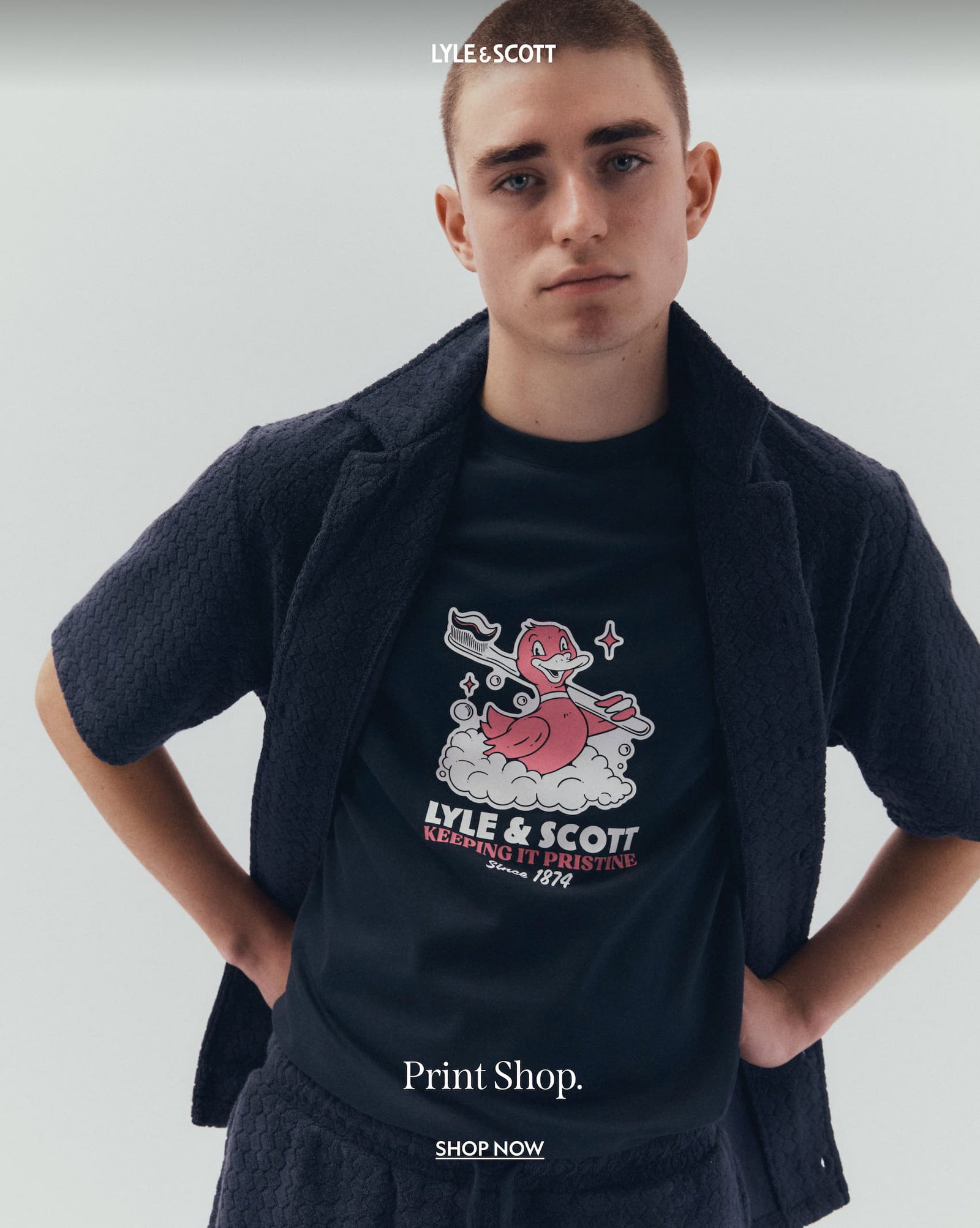 Model wearing short sleeved cotton shirt and linen blend shorts