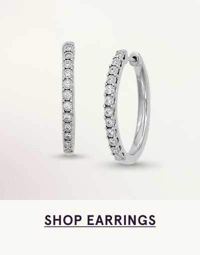 Pair of silver hoops with round diamonds, pavé-set along the front. Click here to shop earrings