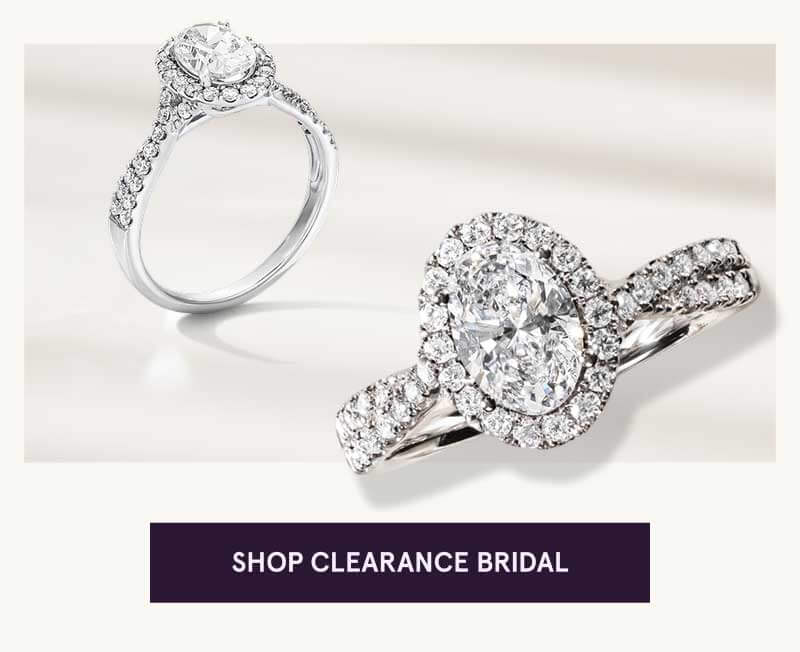 Two silver-toned diamond halo rings, encrusted with diamonds, both oval-cut. Click here to shop clearance bridal 