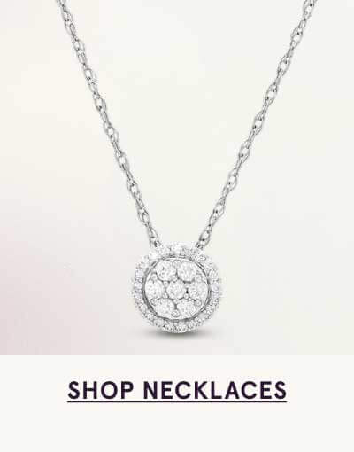 Pendant with circular cluster of round diamonds, framed by diamond halo on chain. Click here to shop necklaces