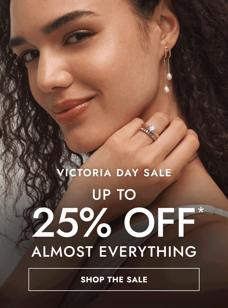 Woman wearing drop pearl earrings and diamond rings. Victoria day sale, up to 25% Off almost everything. Click shop the sale.