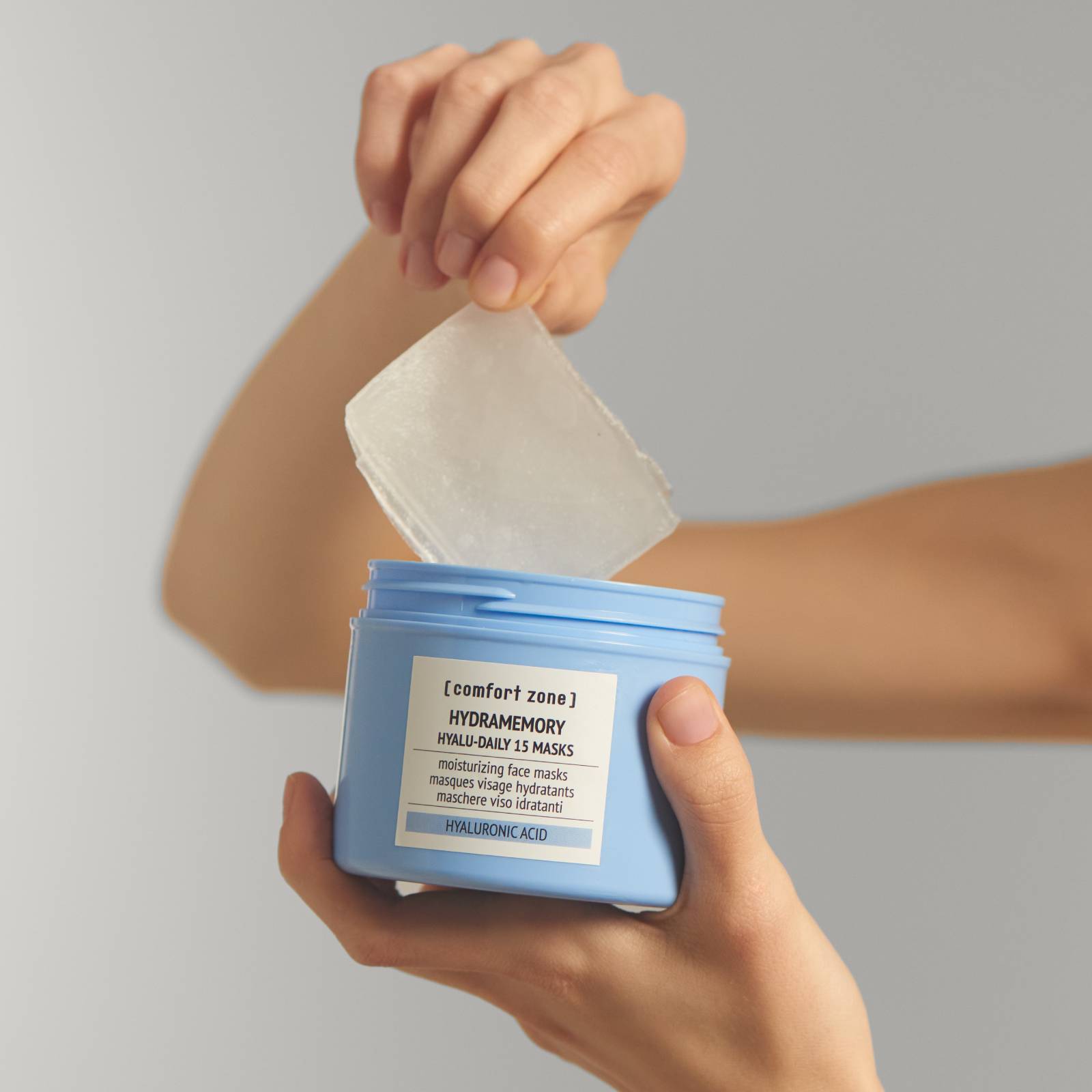 hands reaching into jar of Hydramemory sheet masks