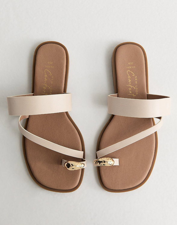 Model wearing a brown polka dot midi dress with ruffle straps, styled with brown sandals, gold jewellery, and a small handbag.