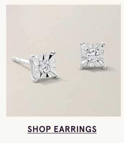 Square-cut diamond studs, with circular stone on center. Click here to shop earrings