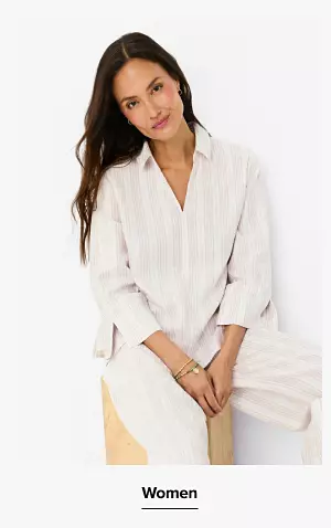 A woman in a white shirt and matching pants. Shop women.