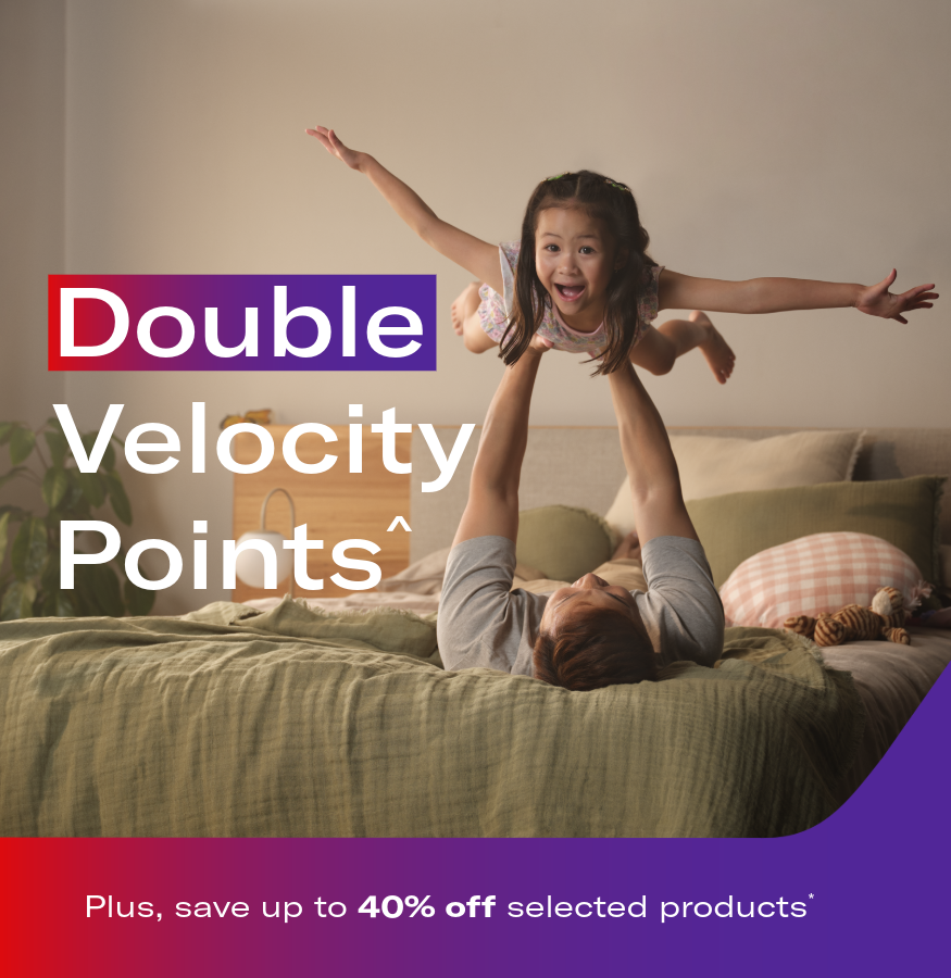 Parent lifting a child playfully in a bedroom. Headline: Double Velocity Points.^ Plus, save up to 40% off selected products*