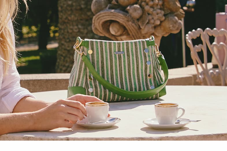 Model having morning coffee at table with Bryant sml in pickle gold. 