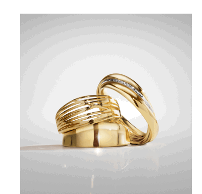 Yellow gold rings featuring one with a wide polished band, one layered design with curved lines and diamond accents.