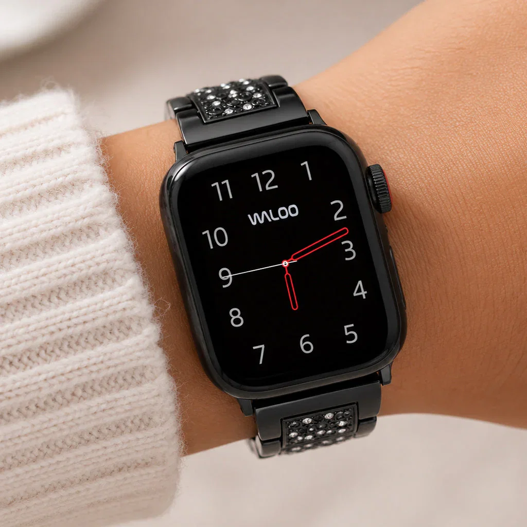 Black Waloo smartwatch with crystal-studded band displaying time on wrist, worn with cream sweater.