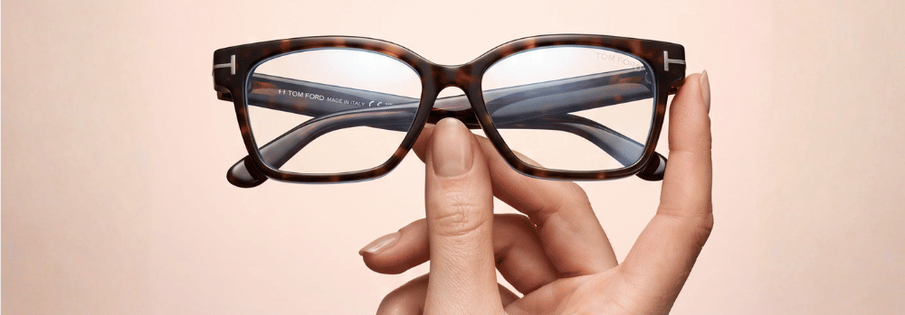 Model holding Tom Ford Glasses