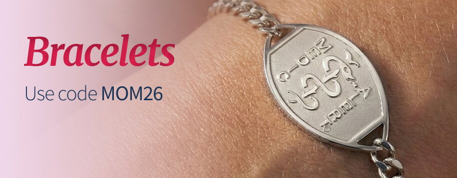 Close-up shot of a person's wrist wearing a MedicAlert silver chain bracelet. The bracelet's large, silver ID tag features an engraved MedicAlert logo. Red title text reads 'Bracelets'. Below the title, smaller text says, 'Use code MOM26'.