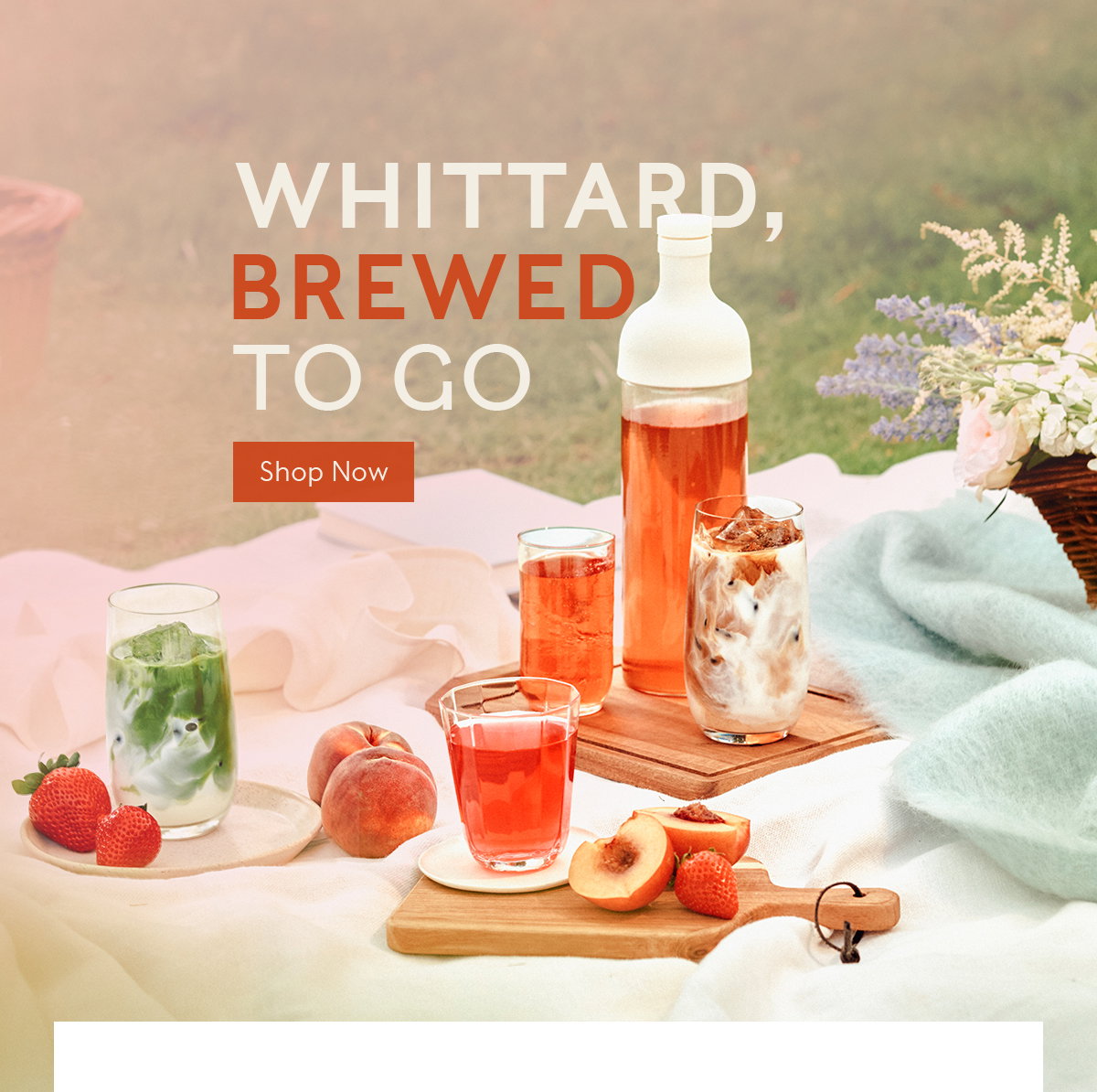 Image shows the Cold Brew Tea Bottle pouring out a fruity tea into a glass filled with ice. The words 'Whittard Wherever You Wander' is overlaid onto the image above the glass.