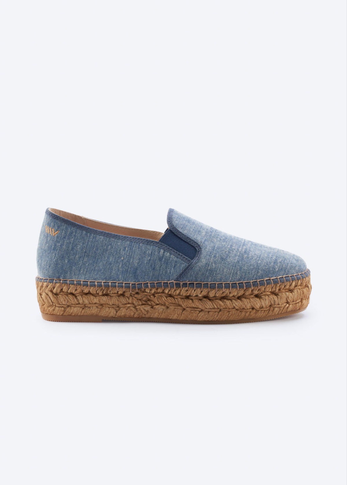 Denim blue canvas platform espadrille flats with braided jute sole on a clean background.