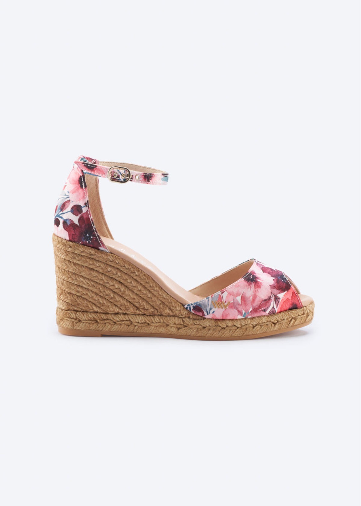 Floral espadrille wedge sandals with ankle strap and braided jute heel on a clean background.