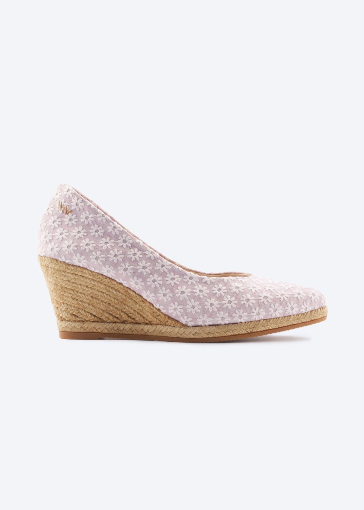 Light pink patterned espadrille wedges with espadrille heel on a clean background.