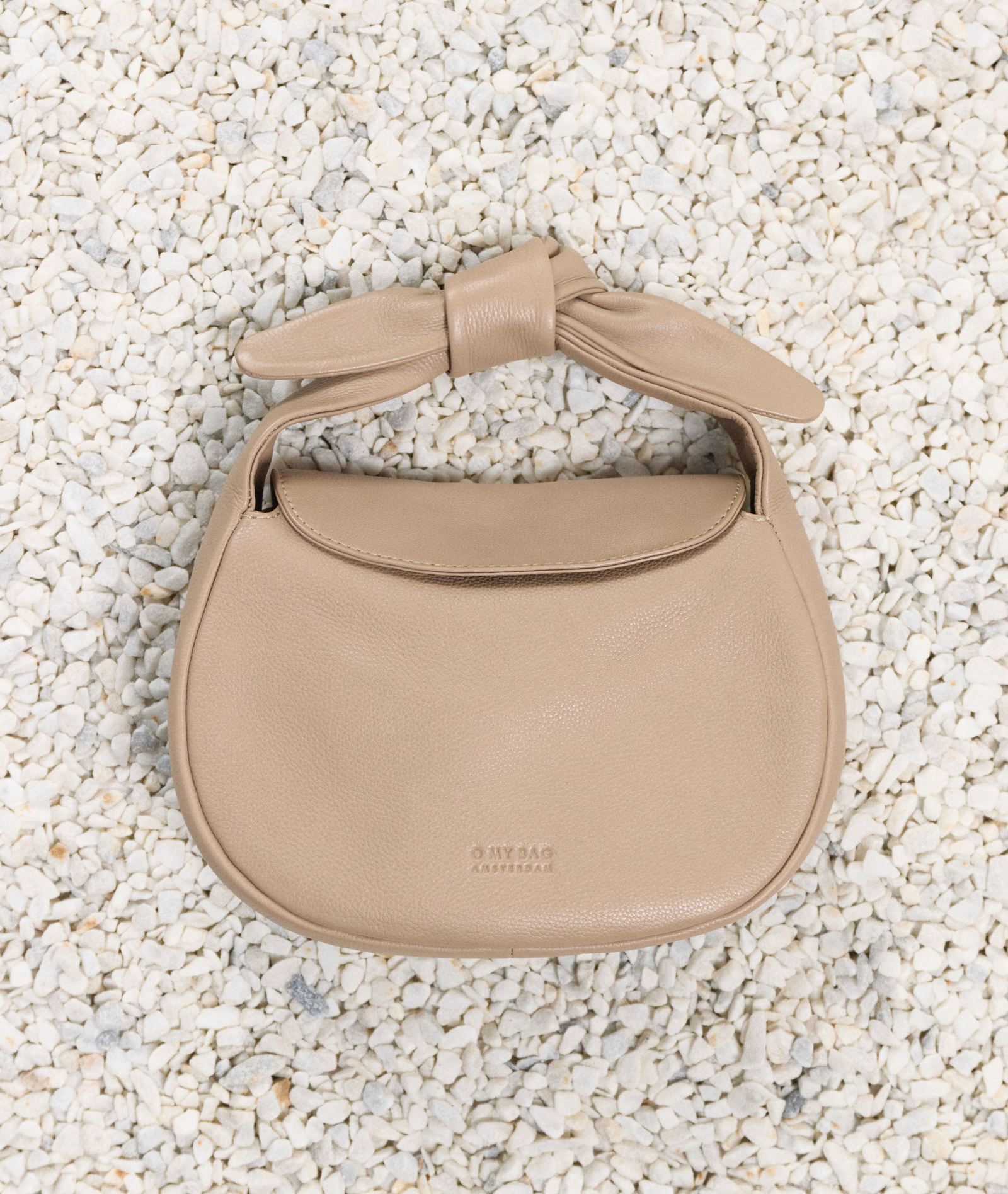 Coco in Dark Sand on a Rocky Beach