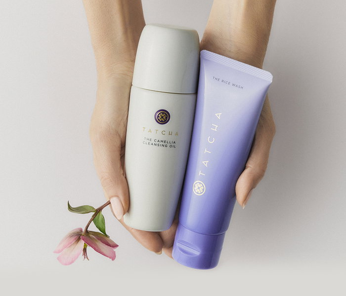 A selection of Tatcha face cleansers held in hands