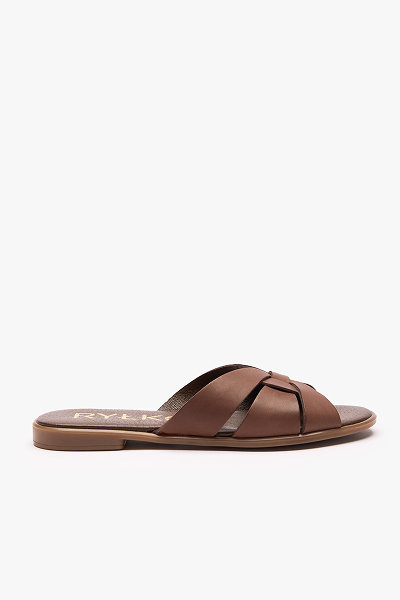 Brown leather slide sandal with criss-cross straps and flat sole on white background.