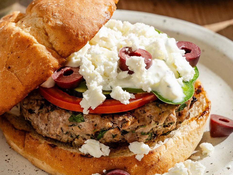 A Greek lamb burger on a plate.