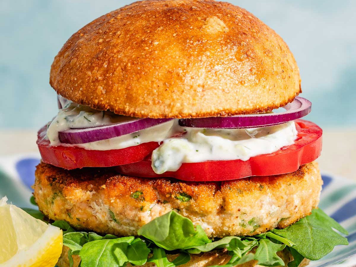 A salmon burger on a plate.