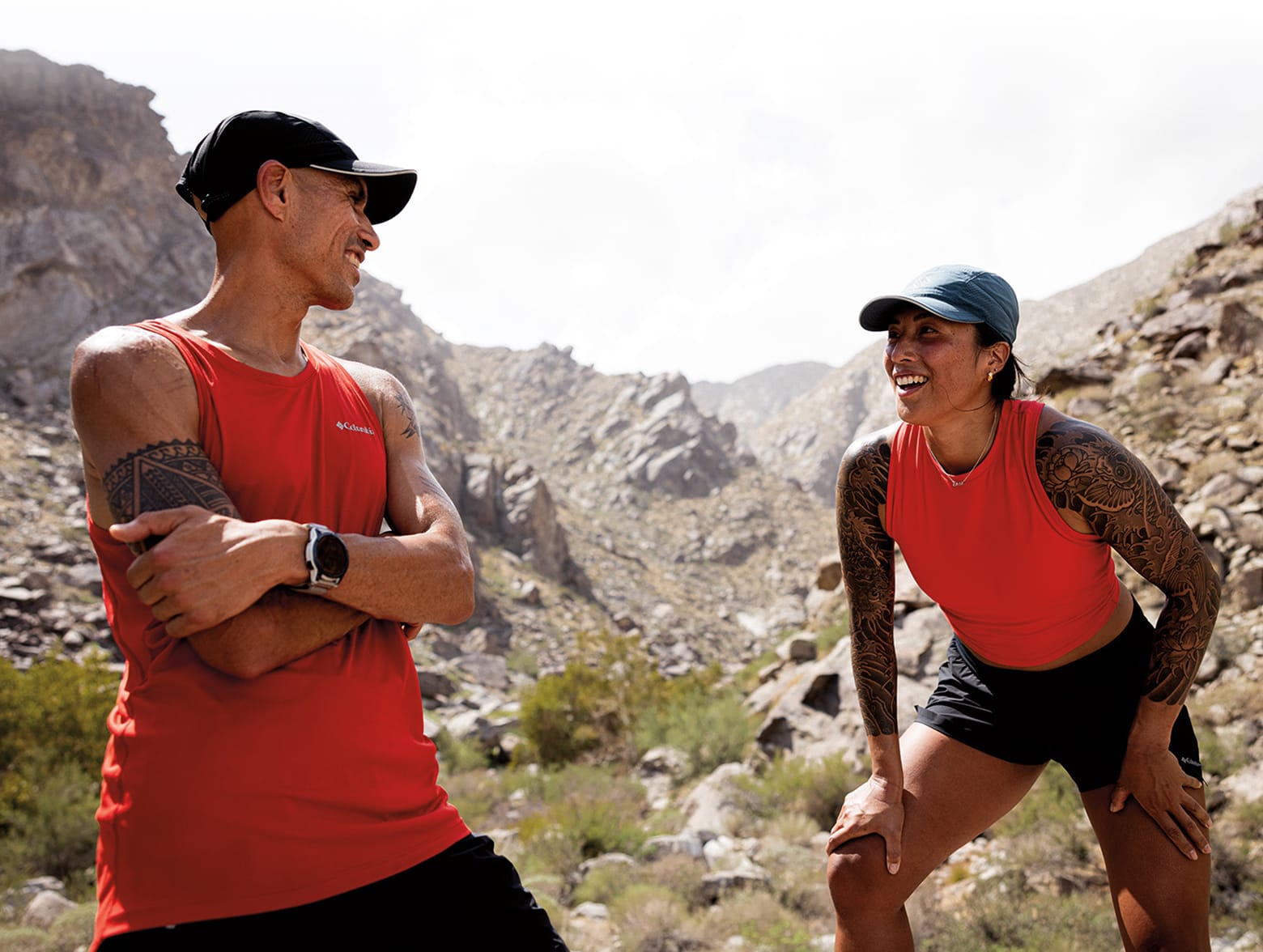 Man and woman in Columbia gear in a rocky wilderness.