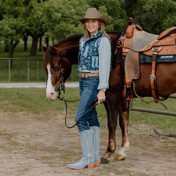 Kristin Kiseljack standing by a horse.