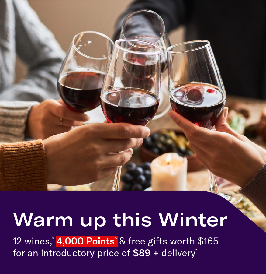 Hands toasting with glasses of red wine. Headline: Warm up this Winter. 12 wines,* 4,000 Points^ & free gifts worth $165 for an introductory price of $89 + delivery*